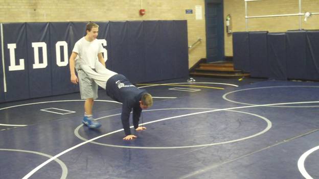 C:\Users\John\Desktop\Hewlett Wrestling Strength\pics\Wrestling Training Tips How to  Improve you Top game and leg riding ability with partner wheel barrow walks Frame - 371.jpg